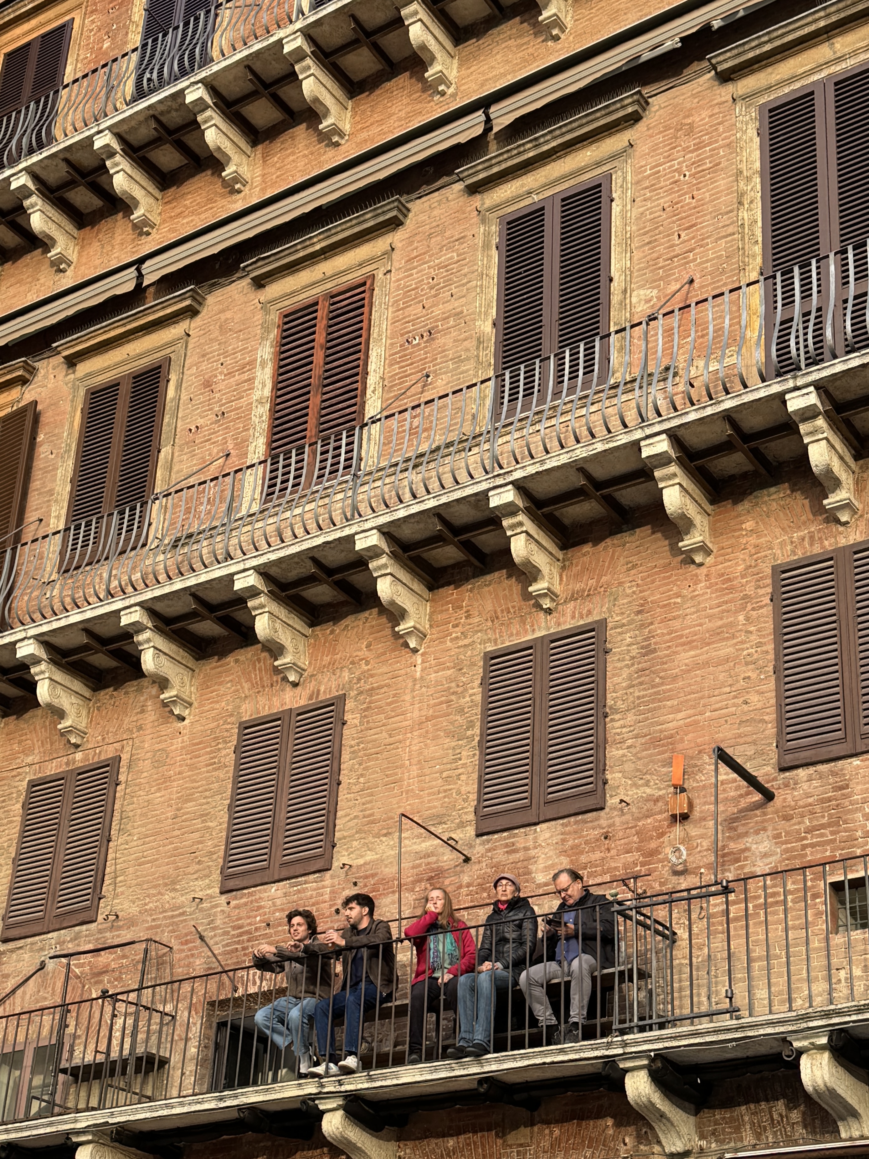 People sitting together on a balcony