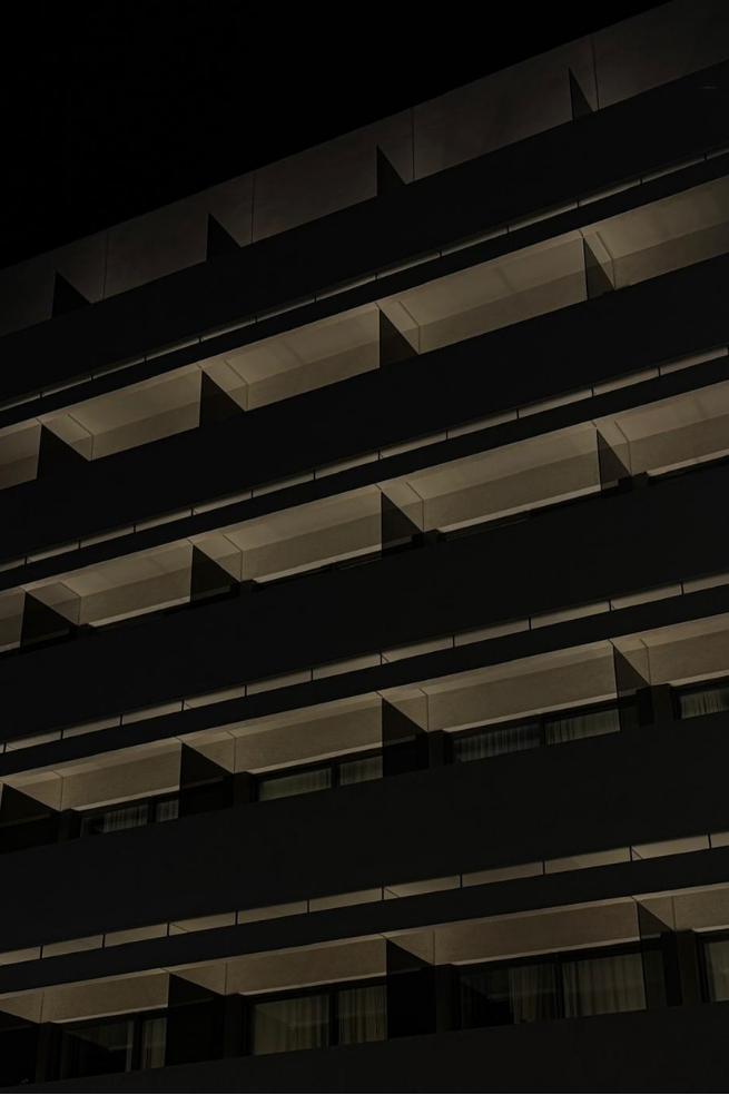 Dark modern facade with repeating balconies