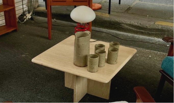 Furniture and ceramics displayed on a city street
